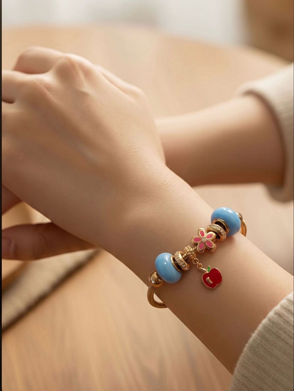 Gold-Tone Charm Bracelet with Blue Beads and Red Apple Charm